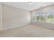 Bright bedroom featuring three large windows offering natural light and carpet flooring at 1954 Summit Trace Circle Northwest, Atlanta, GA 30318