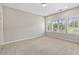 Bright, carpeted bedroom with natural light from large windows, offering a serene view at 1954 Summit Trace Circle Northwest, Atlanta, GA 30318