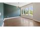 Well-lit dining area featuring hardwood floors, three large windows, and modern lighting at 1954 Summit Trace Circle Northwest, Atlanta, GA 30318