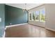 Bright dining area featuring hardwood floors, a striking modern light fixture, and plentiful windows at 1954 Summit Trace Circle Northwest, Atlanta, GA 30318
