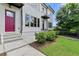 Townhome exterior featuring a vibrant red door, modern windows, and well-kept landscaping at 1954 Summit Trace Circle Northwest, Atlanta, GA 30318