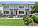 Charming townhome with red door, black awnings, and a beautifully manicured front yard at 1954 Summit Trace Circle Northwest, Atlanta, GA 30318