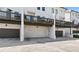 Row of modern garages featuring a dark colored doors and concrete parking space at 1954 Summit Trace Circle Northwest, Atlanta, GA 30318