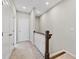 Well-lit hallway with neutral paint, carpet flooring, and a staircase with wooden railings at 1954 Summit Trace Circle Northwest, Atlanta, GA 30318