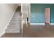 Inviting hallway with hardwood floors, stairs, and a teal accent wall leading to the kitchen at 1954 Summit Trace Circle Northwest, Atlanta, GA 30318
