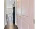 Hallway with pink doors, wood floors, and a view of the kitchen and backyard at 1954 Summit Trace Circle Northwest, Atlanta, GA 30318
