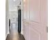 Hallway featuring hardwood floors, a pink door, and a view into the kitchen at 1954 Summit Trace Circle Northwest, Atlanta, GA 30318