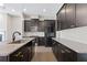 Modern kitchen with granite countertops, black cabinets, and stainless steel appliances at 1954 Summit Trace Circle Northwest, Atlanta, GA 30318