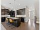 Stylish kitchen with an island, granite countertops, and dark cabinetry, seamlessly connecting to the living space at 1954 Summit Trace Circle Northwest, Atlanta, GA 30318