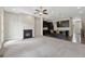 Open living room with fireplace flows into modern kitchen with island at 1954 Summit Trace Circle Northwest, Atlanta, GA 30318