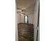 A clean and bright bedroom with wood floors, a ceiling fan, white walls, window with curtain, and a closet at 101 Royal Way, Mcdonough, GA 30252