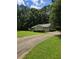A driveway leads to a one-story home with an attached garage and well-maintained landscaping at 101 Royal Way, Mcdonough, GA 30252