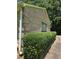 The side of a brick home shows well-maintained bushes along the driveway with a single window at 101 Royal Way, Mcdonough, GA 30252