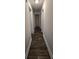 Hallway with wood floors and white trim and two doors; one to a closet and one to another room at 101 Royal Way, Mcdonough, GA 30252