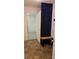 Hallway featuring tile floors, a bench, a navy blue door and an entrance into a bedroom at 101 Royal Way, Mcdonough, GA 30252