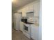This kitchen features white cabinets, white appliances and tile flooring at 101 Royal Way, Mcdonough, GA 30252