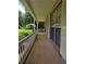 A long, covered porch with brick pillars and white railing runs along the side of this home at 101 Royal Way, Mcdonough, GA 30252