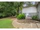 Backyard with a small porch, some mature trees, and healthy green grass at 232 Whitworth Sw Dr, Atlanta, GA 30331
