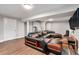 Finished basement featuring a modern sectional sofa, new laminate floors, and a tv at 232 Whitworth Sw Dr, Atlanta, GA 30331