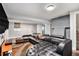 Finished basement featuring a large sectional sofa, painted brick wall, and neutral colors at 232 Whitworth Sw Dr, Atlanta, GA 30331