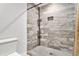 Bathroom featuring wood-look tile shower with dark fixtures and built in shower storage at 232 Whitworth Sw Dr, Atlanta, GA 30331