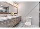 Modern bathroom with double sink vanity, updated fixtures, large mirror and decorative lighting at 232 Whitworth Sw Dr, Atlanta, GA 30331