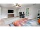 Bright and open bedroom with a platform bed, ceiling fan, natural light and an adjacent office space at 232 Whitworth Sw Dr, Atlanta, GA 30331