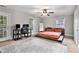 Spacious bedroom featuring a platform bed, ceiling fan, natural light and an adjacent office space at 232 Whitworth Sw Dr, Atlanta, GA 30331