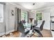 Contemporary dining room with modern table and chairs, hardwood floors, stylish chandelier and sun-filled windows at 232 Whitworth Sw Dr, Atlanta, GA 30331
