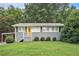 Charming single story home with gray brick and siding, grassy front lawn and updated stairs to the yellow front door at 232 Whitworth Sw Dr, Atlanta, GA 30331