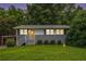Charming single story home with gray brick and siding, grassy front lawn and updated stairs to the yellow front door at 232 Whitworth Sw Dr, Atlanta, GA 30331