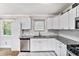 Bright kitchen with white cabinets, subway tile backsplash, stainless steel appliances and granite countertops at 232 Whitworth Sw Dr, Atlanta, GA 30331
