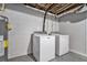 Basement laundry room featuring standard white washer and dryer next to a water heater at 232 Whitworth Sw Dr, Atlanta, GA 30331