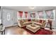 Inviting living room featuring a large sectional, hardwood floors, modern lighting, and a bright front door at 232 Whitworth Sw Dr, Atlanta, GA 30331