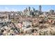 An aerial view of townhomes with a skyline background in an urban community setting at 326 Brownstones Ne Cir, Atlanta, GA 30312