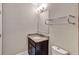 Bathroom vanity with granite countertop, dark wood cabinet and decorative mirror and towel bar at 326 Brownstones Ne Cir, Atlanta, GA 30312