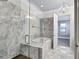 Luxurious bathroom featuring a marble-tiled shower, soaking tub, and modern light fixtures at 326 Brownstones Ne Cir, Atlanta, GA 30312