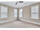 Bright bedroom with three large windows, neutral walls and plush carpeting at 326 Brownstones Ne Cir, Atlanta, GA 30312