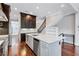 This kitchen features an island with seating, stainless appliances and leads to a staircase at 326 Brownstones Ne Cir, Atlanta, GA 30312