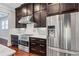Modern kitchen with stainless steel appliances, gas range and dark wood cabinets at 326 Brownstones Ne Cir, Atlanta, GA 30312