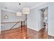Landing with hardwood floors, white molding, and elegant iron railing, leading to the staircase at 326 Brownstones Ne Cir, Atlanta, GA 30312