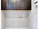 Clean laundry room with upper cabinets and new appliances at 326 Brownstones Ne Cir, Atlanta, GA 30312