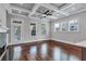 Living room featuring a stone fireplace, hardwood floors and multiple windows and access to the outside at 326 Brownstones Ne Cir, Atlanta, GA 30312