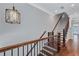 Staircase with hardwood steps, iron railing, and modern lighting, leading to the upper level at 326 Brownstones Ne Cir, Atlanta, GA 30312