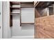 Spacious walk-in closet boasting custom shelving and a built-in mirrored dresser at 326 Brownstones Ne Cir, Atlanta, GA 30312