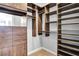 Custom walk-in closet with wood shelving, drawers, and ample storage space at 326 Brownstones Ne Cir, Atlanta, GA 30312