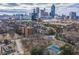 Stunning aerial view of property featuring tennis courts and a breathtaking downtown skyline backdrop at 395 Central Park Ne Pl # 610, Atlanta, GA 30312