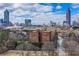 Gorgeous aerial view of brick condo building with the city skyline as its backdrop on a sunny day at 395 Central Park Ne Pl # 610, Atlanta, GA 30312