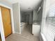 Well-lit bathroom featuring a glass shower, tile floors, and dual granite countertops at 395 Central Park Ne Pl # 610, Atlanta, GA 30312