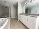 Beautiful bathroom featuring a soaking tub, shower, and dual granite countertops at 395 Central Park Ne Pl # 610, Atlanta, GA 30312